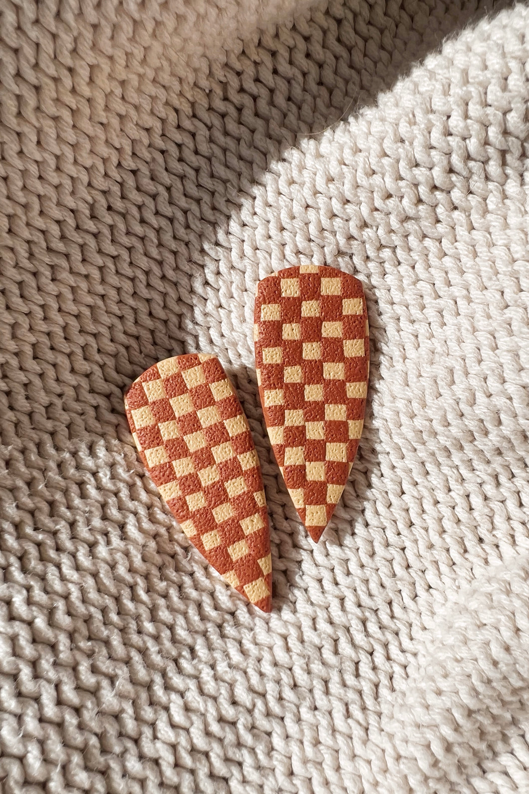 dagger studs • orange checkered