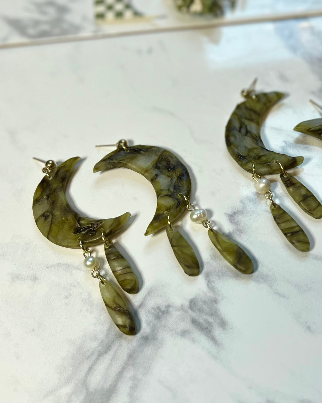 moon dangles in green